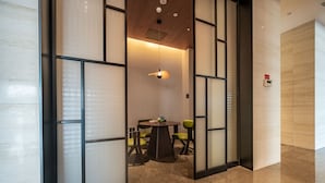 A modern interior with a round table, chairs, and a ceiling light. - Fairfield by Marriott Urumqi Beijing Road (Urumqi)