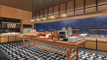 A buffet setup with a variety of food items and a coffee machine.