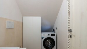 A compact laundry room with a washing machine, a dryer, and a toilet. - Villa in Ostuni with 3 bedrooms sleeps 8 (Ostuni)