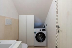 A compact laundry room with a washing machine, a dryer, and a toilet. - Villa in Ostuni with 3 bedrooms sleeps 8 (Ostuni)