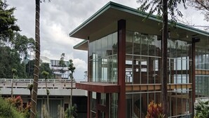Un bâtiment moderne doté de grandes fenêtres en verre et d’un toit plat.