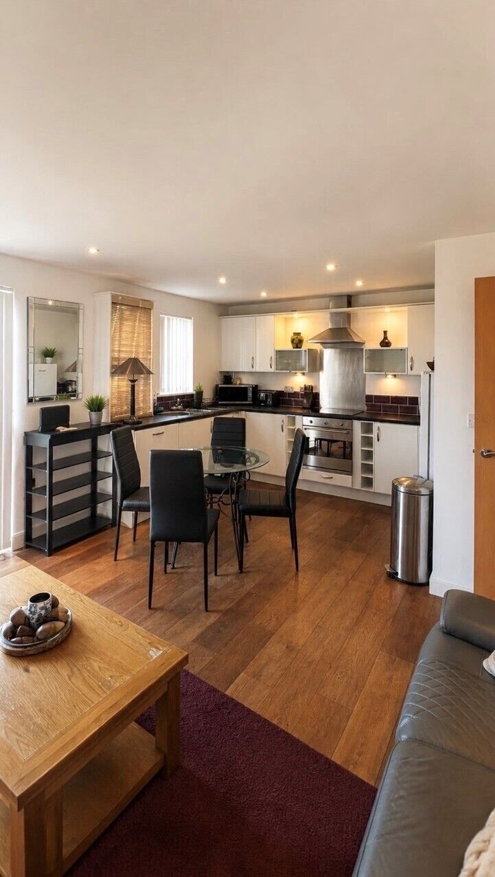 A compact living space with a kitchenette, dining area, and seating area.