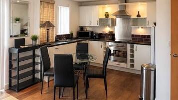 A compact living space with a kitchenette, dining area, and seating area.