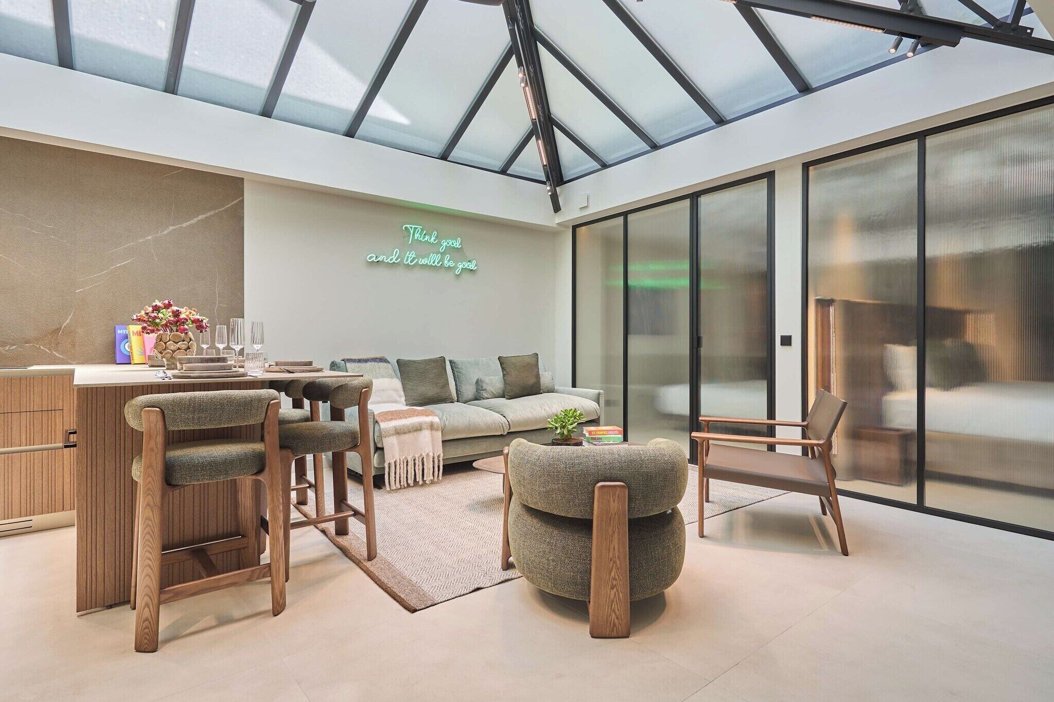 A modern interior with a dining area, seating, and a large glass wall.