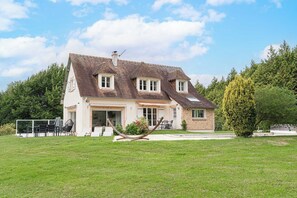 A two-story house with a sloped roof, a front porch, and a small attached structure. - Exceptional House with Pool 12P – Englesqueville (Englesqueville-en-Auge)