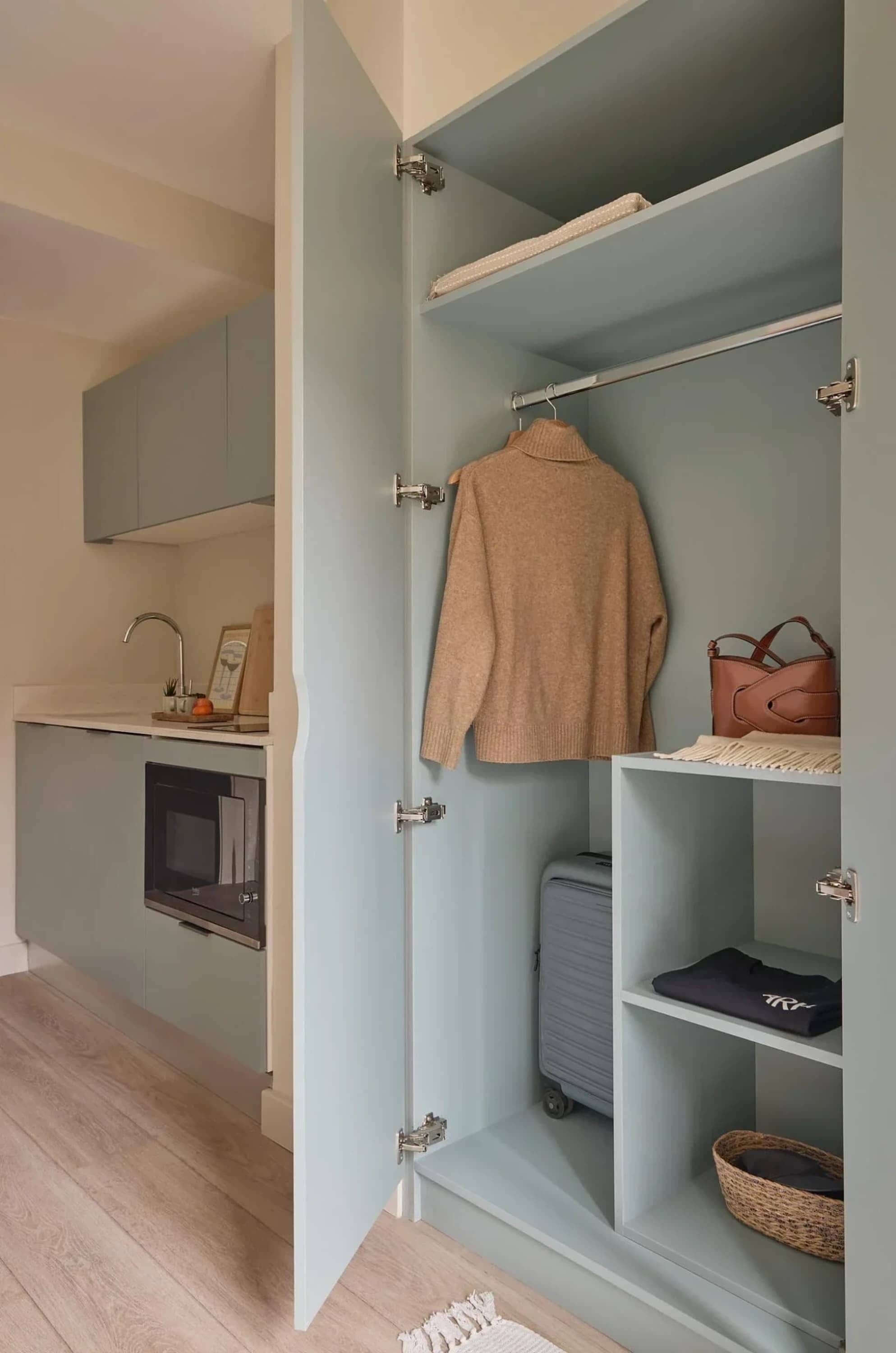A modern kitchen with a built-in oven, a microwave, and a countertop with a sink.