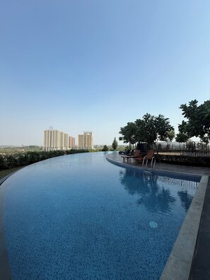 A swimming pool with a view of high-rise buildings in the background. - Modern Japanese Suite with Fast WiFi, Pool and Gym near Meikarta (Cikarang Selatan  (West Java))