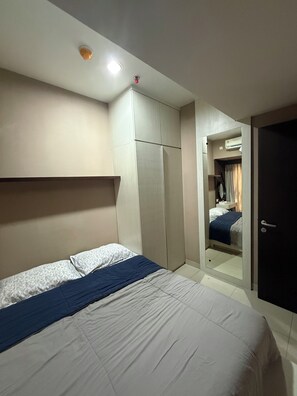 Ein Hotelzimmer mit Bett, Kleiderschrank und Klimaanlage.