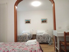 A room with two beds, a desk, and a chair. There are two framed pictures on the wall. - The perfect base for enchanting hikes in the Dolomites and the famous Pedavena Brewery (Pedavena)