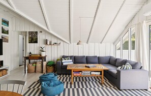 A modern living room with a sofa, coffee table, and a checkered floor. - 3 bedroom lovely home in Dronningmølle (Dronningmølle)