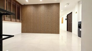 A modern interior with a wooden slat wall, a water dispenser, and a clean tiled floor.