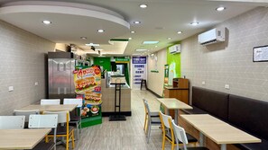 A restaurant with booths and tables, a food display, and a sign for rooms for rent. - Patong Superior Beachfront Double Room (Tambon Patong)
