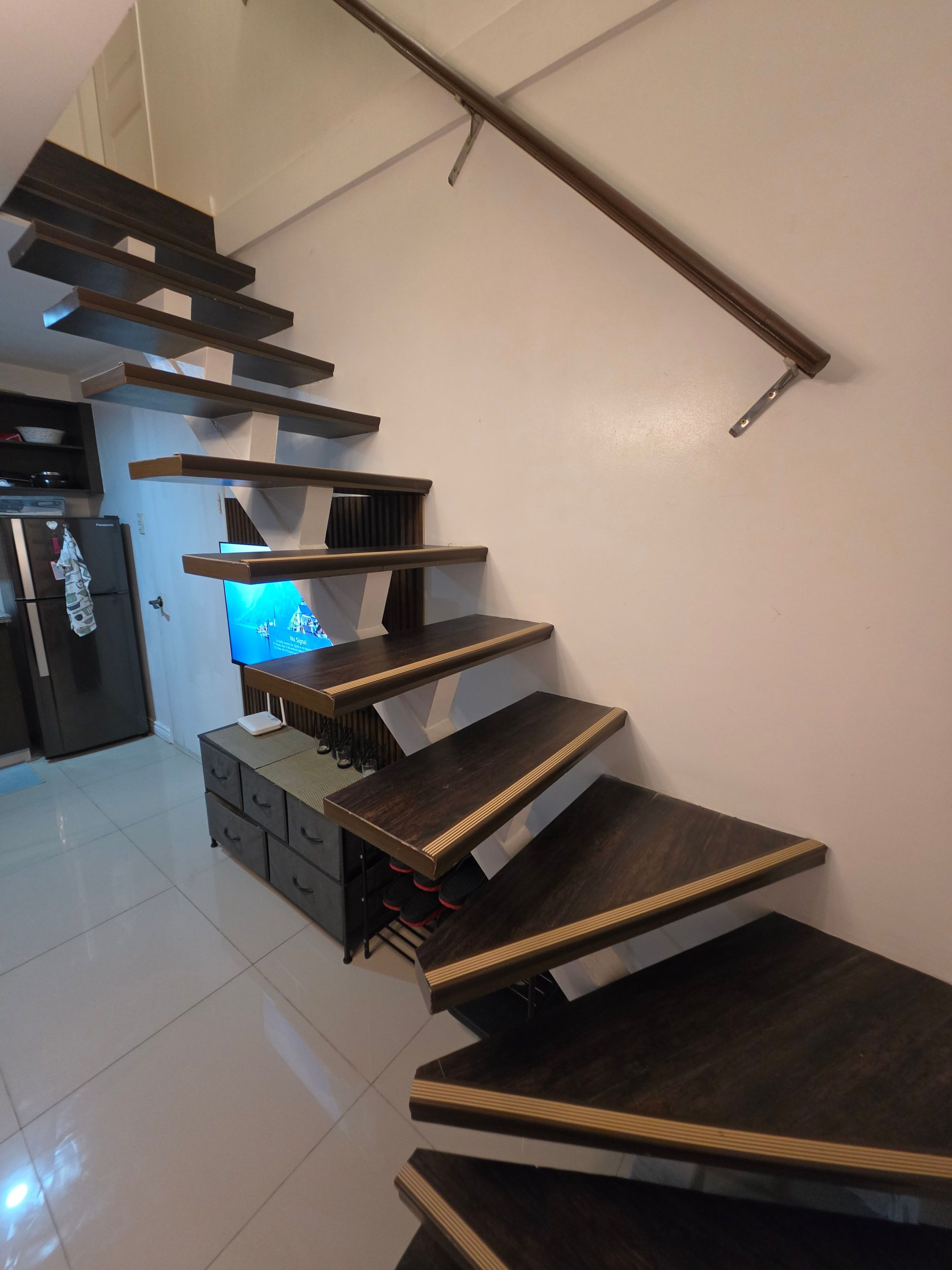 A modern interior with a staircase leading to a living area.