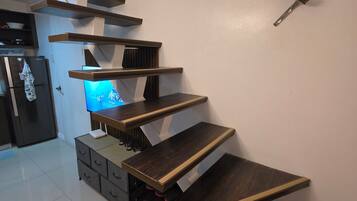 A modern interior with a staircase leading to a living area.