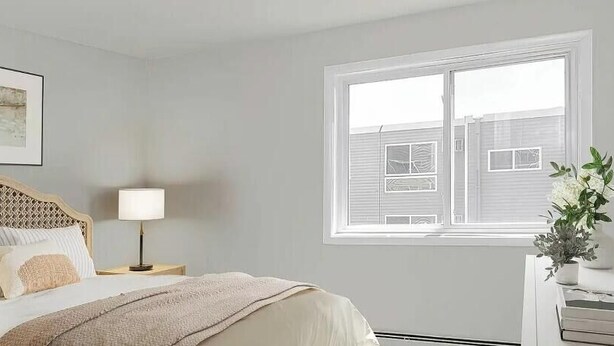 A bedroom with a bed, bedside table, lamp, window, and a framed picture on the wall. - Cozy MSP 1BR Retreat: Pets OK, Pool & Gym-159/nt, 4499/mn{Negotiable} (Minneapolis)