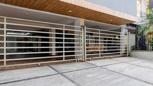 A covered outdoor area with a wooden ceiling and a metal gate. - Collection O Infocity Square Bhubaneswar (Bhubaneshwar)