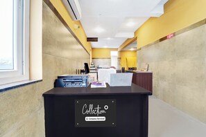 A reception desk with a sign indicating it's a company-serviced area.