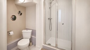 A bathroom with a toilet, a shower enclosure, and two wall-mounted toilet paper holders. - Welcome to The Angel Studio, located in the heart of vibrant Angel, Islington, (London)