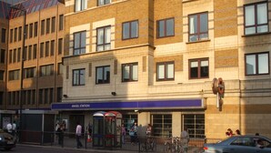 A multi-story building with a sign for 'Angel Station' indicating a transportation hub. - Welcome to The Angel Studio, located in the heart of vibrant Angel, Islington, (London)