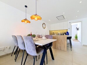 A modern kitchen with white cabinets, a central island, and pendant lighting. - Private Roof Terrace & Pool View Penthouse (Mar de Cristal)