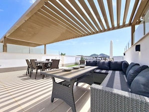 An outdoor patio with a dining table, chairs, and a sofa. - Private Roof Terrace & Pool View Penthouse (Mar de Cristal)