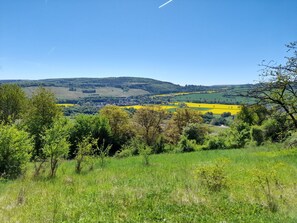 A rural landscape with rolling hills, a small village, and fields of yellow crops. - Holiday Home 'Am See' with Lake View, Private Terrace and Private Garden (Sundern)
