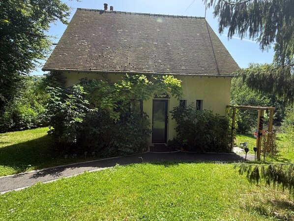 A single-story house with a sloped roof, a front door, and a small porch area.