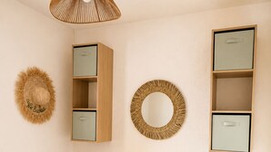 A bedroom with two single beds, a nightstand with two lamps, a mirror, and storage cabinets. - Casa Arletta | 4 people | AC | private parking | free Wi-Fi | beaches within walking distance (Les saintes maries de la mer)