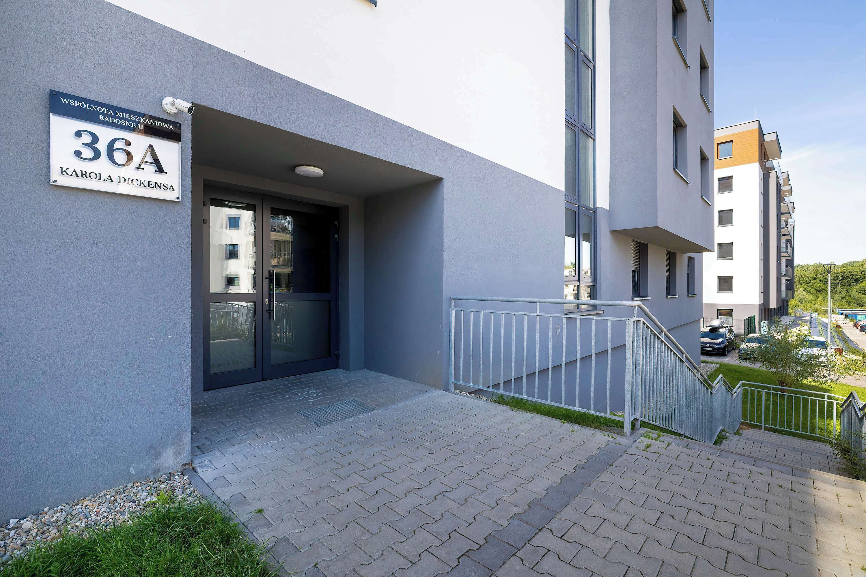 An entrance to a building with a sign indicating the address and name.