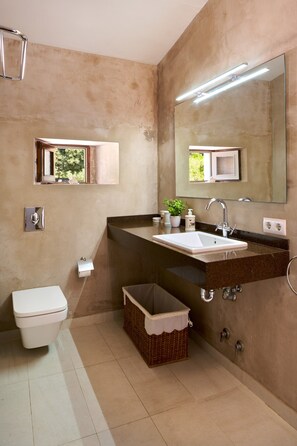 A bathroom with a toilet, sink, mirror, and a small window. - Hillside Villa With Pool for 5 (Pollença)