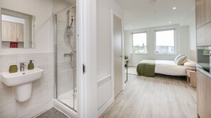 A modern bathroom with a glass shower enclosure, a sink, and a mirror. - Student Only The Sailworks (Lancaster)