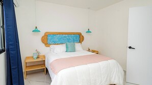 A bedroom with a bed, bedside tables, a nightstand, a door, and a window with curtains. - Villa for 7 People in Punta Cana (Punta Cana)