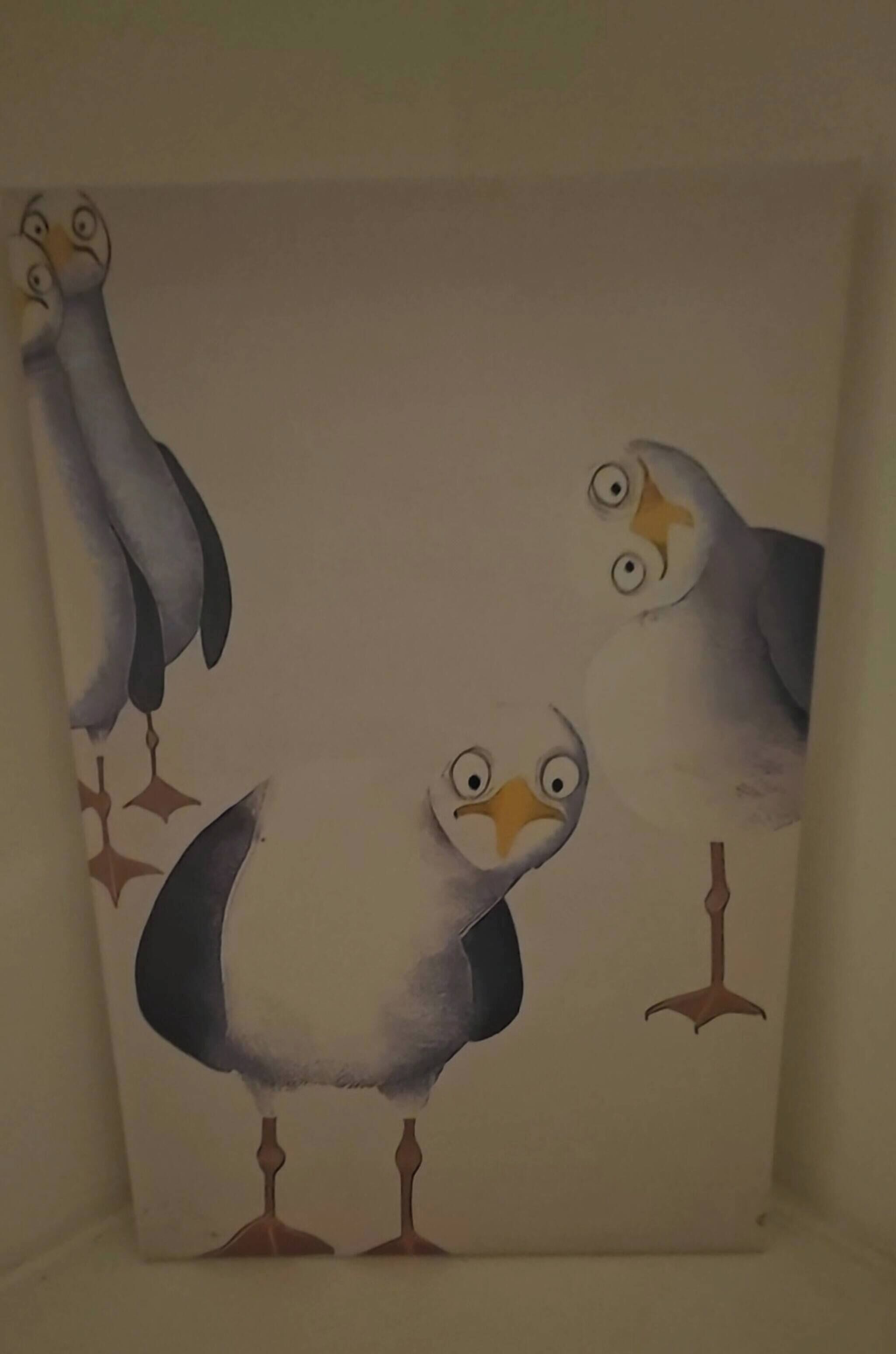 A painting of three birds on a wall.