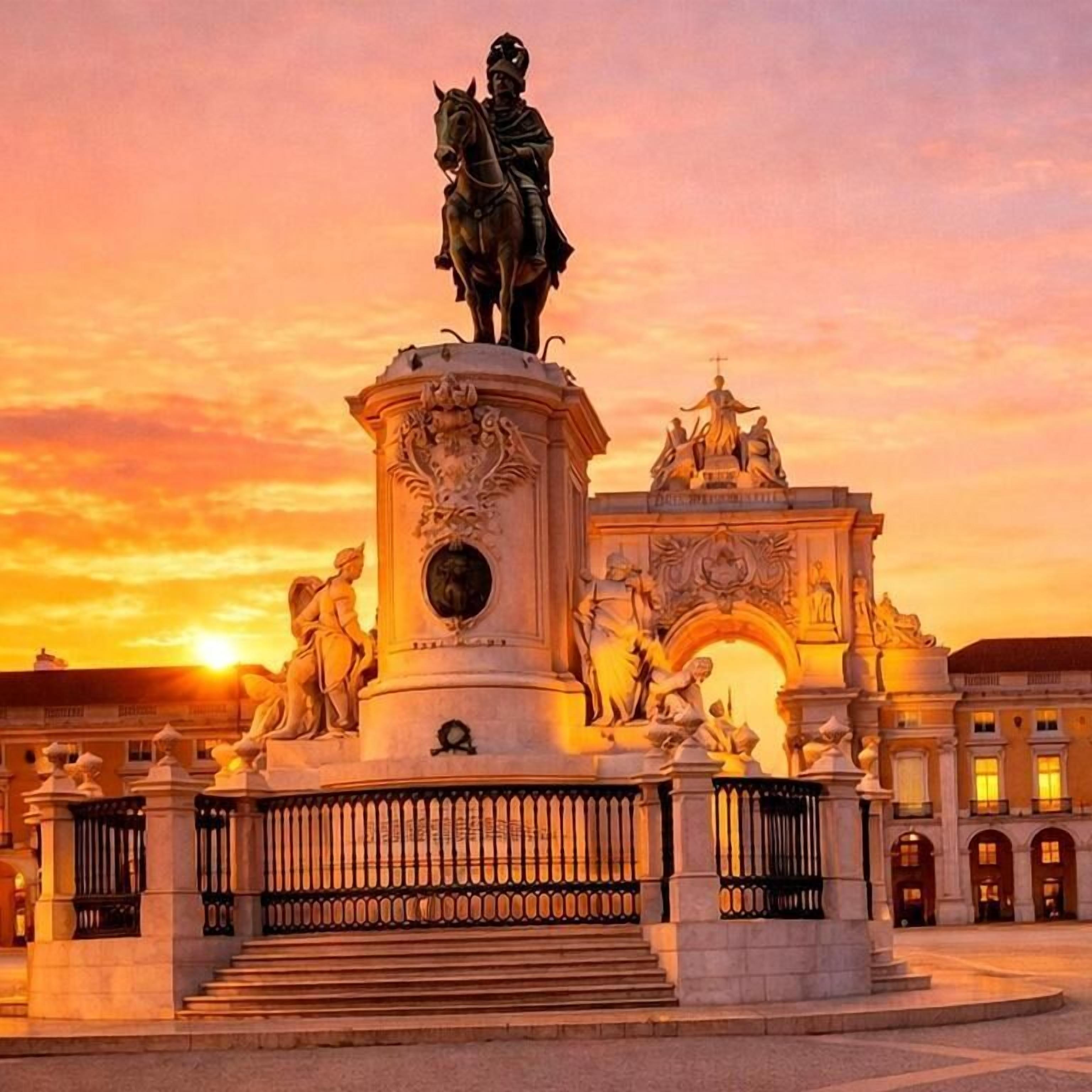 A historical monument with a statue on top, surrounded by classical architecture and a grand archway.
