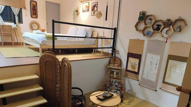 A compact room with a bunk bed, a small table with a teapot, and a chair. - Room-tranquil Retreat in the Heart of Ba (Bangkok)