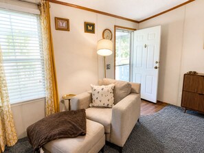 A cozy living room with a beige sofa, a brown throw blanket, and a lamp. - Nostalgic 3-bedroom doublewide in Denver (Denver)
