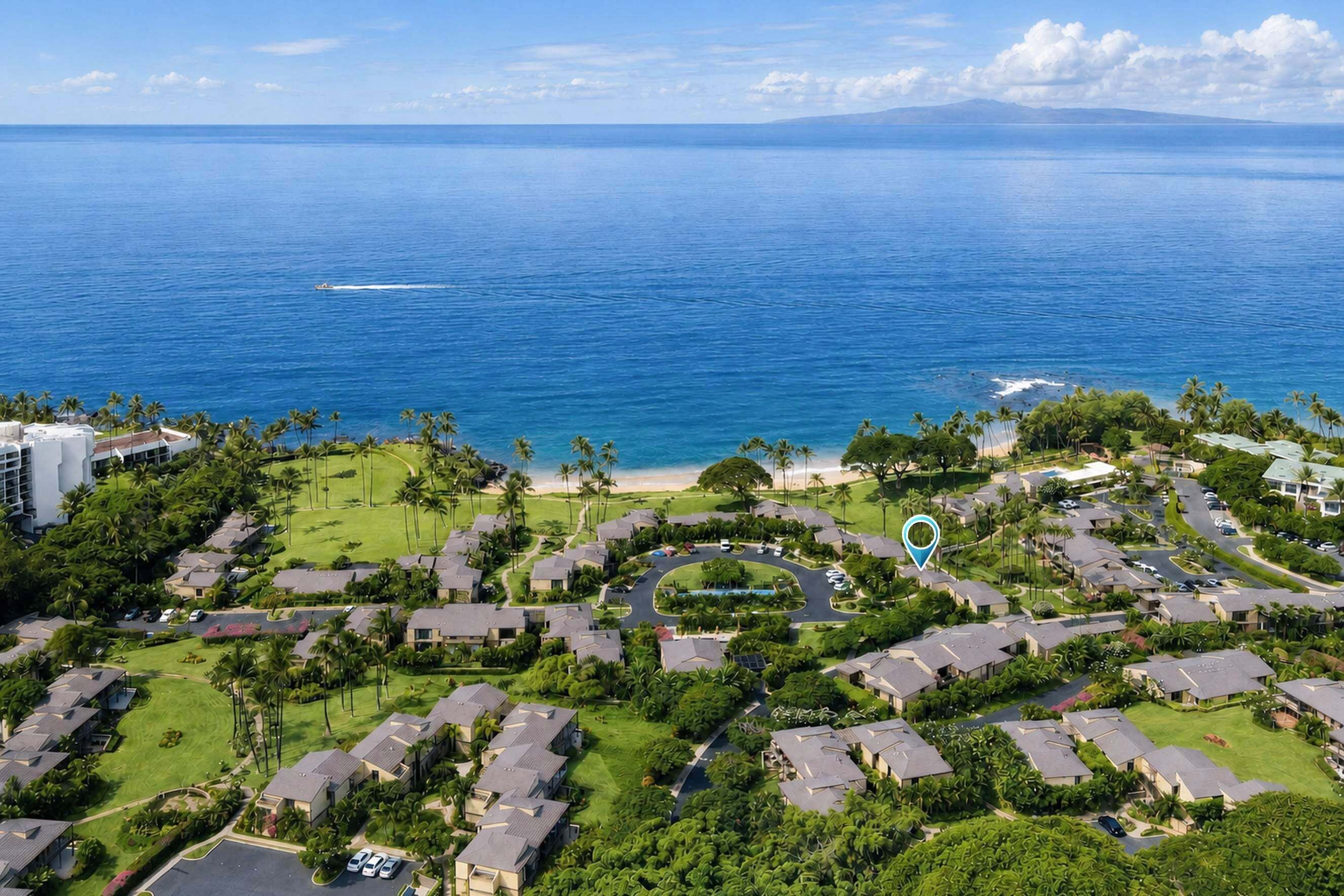 Un quartier résidentiel situé sur la côte, avec des maisons, une plage et une vue dégagée sur l’océan.