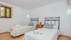 A room with two beds, each with a headboard, a nightstand, and a lamp. - Peaceful Rural Haven With Pool (Pollença)