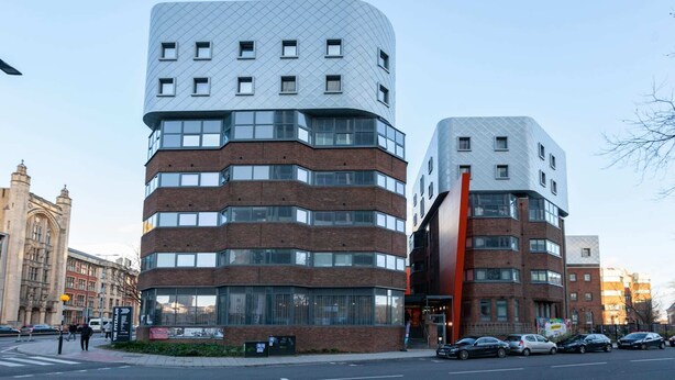 A modern building with a unique angular design, featuring multiple floors and large windows. - Student Only The Fitzalan (Cardiff)