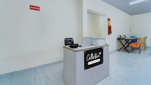 A reception desk with a sign indicating a company-serviced collection area.