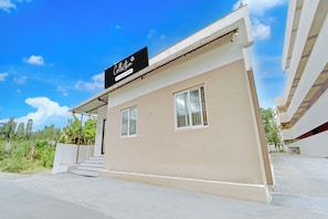 A modern building with a sign that reads 'Collection Company-Serviced'.