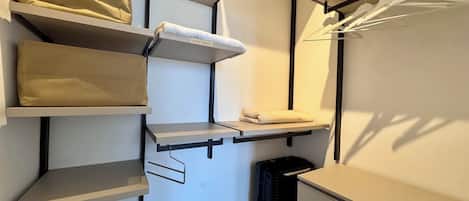 A compact storage unit with multiple shelves and drawers, including a section labeled 'EXTRA TOILETS.'