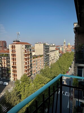 A cityscape with high-rise buildings, a prominent church with a green dome, and a clear sky. - Skyline Design Apartment - Top Floor Next to the Metro (Milano)