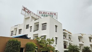 A multi-story building with a sign reading 'ELEGANCE RESORT' and balconies with railings. - Elegance Resort, Vrindavan (Vrindavan)