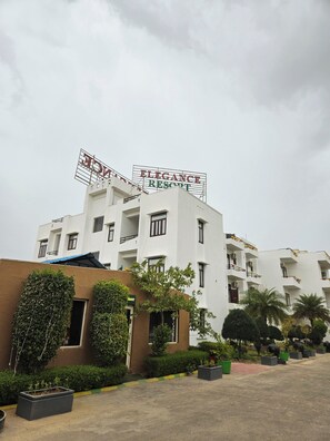 A multi-story building with a sign reading 'ELEGANCE RESORT' and balconies with railings. - Elegance Resort, Vrindavan (Vrindavan)