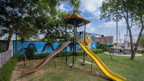A playground with two slides and a climbing structure. - Elegance Resort, Vrindavan (Vrindavan)