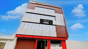A modern building with a sign that reads 'Collection' and 'Company Serviced'. - Super OYO Collection O Subedarganj (Prayagraj)