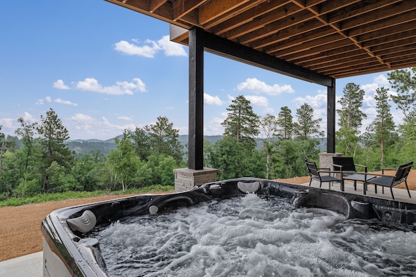 A hot tub area with a view of trees and mountains. - New Hilltop Escape, Sweeping Black Hills Views w/ Hot Tub, Large Driveway (Lead)