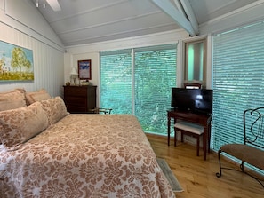 A bedroom with a large bed, a television, a desk, and a chair. - one of a-kind slopeside condo, located just across the street from SM Skiing (Sugar Mountain)