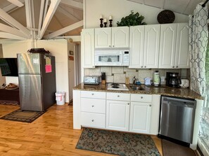A kitchen with white cabinets, a stainless steel refrigerator, a microwave, and a dishwasher. - one of a-kind slopeside condo, located just across the street from SM Skiing (Sugar Mountain)